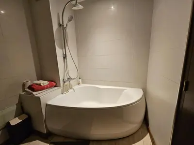 a white tub in a bathroom with a shower at Résidence la paix in Marrakech