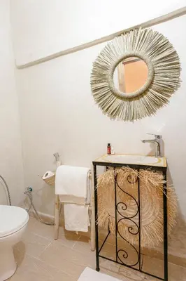 a bathroom with a sink and a mirror on the wall at Abraj Bladi Resort in Marrakech