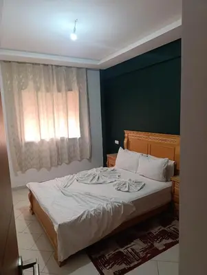 a bedroom with a large white bed with a window at Studio lumineux pour location journalière in Marrakech