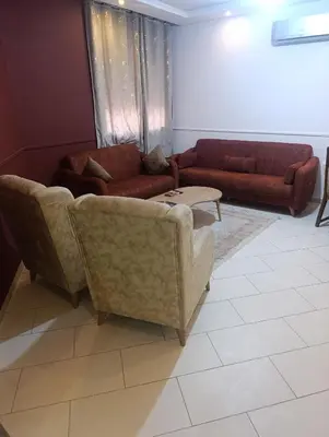 a living room with two couches and a table at Studio lumineux pour location journalière in Marrakech
