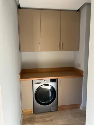 a washer and dryer in a kitchen with cabinets at Central Marrakesh Apartment in Marrakech