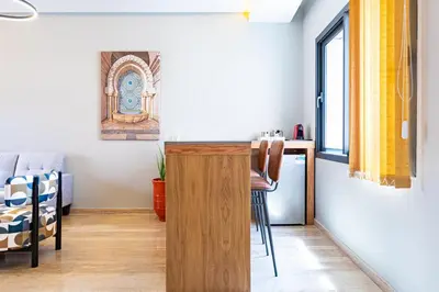 a small kitchen with a desk and a table in a room at Central Marrakesh Apartment in Marrakech