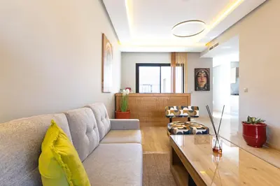 a living room with a couch and a table at Central Marrakesh Apartment in Marrakech