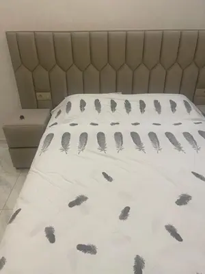 a bed with black feathers on a white comforter at Dar l7aj Brahim in Marrakech