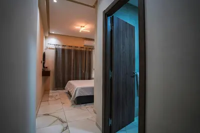 a room with a bed and a door to a bedroom at New and luxurious apartment with a pool in Marrakech