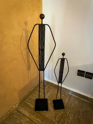 two metal sculptures sitting on the floor in a room at Stunning Patios & Gardens Apartment in Marrakech