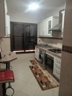 a kitchen with a washer and dryer on the floor at Résidence SOFIA PALMERAIE in Marrakech