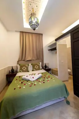 a bedroom with a bed with flowers on it at Riad Dar Yousra in Marrakech