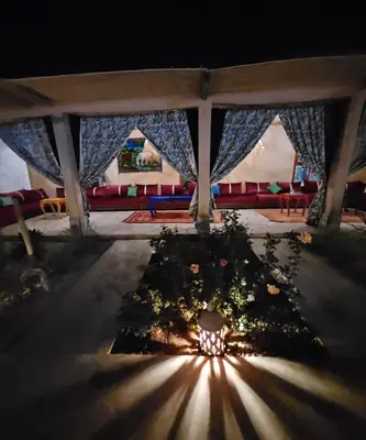 a view of a room with a table with flowers at Maison de vacances avec piscine in Marrakech