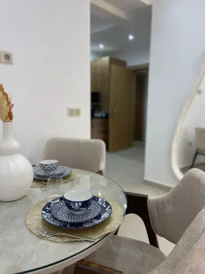 a table with a bowl and plates on it at Logement F2 neuf Gueliz Gare in Marrakech