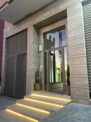 a front door of a building with lights on it at Logement F2 neuf Gueliz Gare in Marrakech