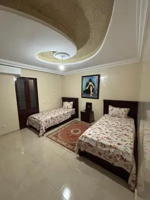 a bedroom with two beds and a circular ceiling at Villa Saber in Marrakech