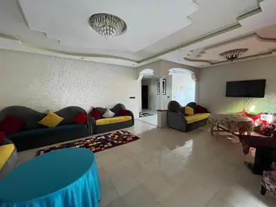 a living room with two couches and a television at Villa Marrakech in Marrakech
