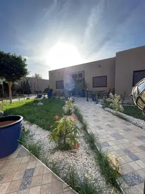 a building with a patio with a garden with plants at Villa Marrakech in Marrakech