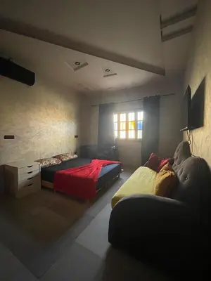 a bedroom with two beds and a couch at Villa Marrakech in Marrakech