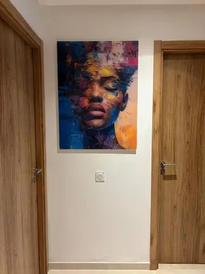 a painting of a woman hanging on a wall at Domaine de Noria Isli 2 - Magnifique 2 chambres - Vue directe sur la piscine in Marrakech