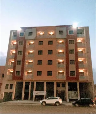 a large building with a car parked in front of it at Cosy appartement au centre ville hivernage marrakech in Marrakech