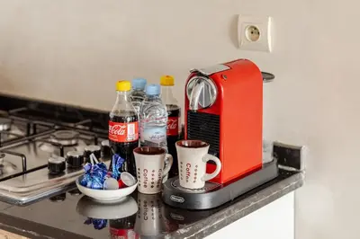 a red toaster sitting on top of a kitchen counter at Cosy appartement au centre ville hivernage marrakech in Marrakech