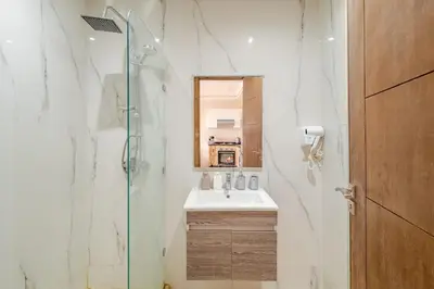 a bathroom with a shower and a sink at Cosy appartement au centre ville hivernage marrakech in Marrakech