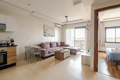 a living room with a couch and a table at Cosy appartement au centre ville hivernage marrakech in Marrakech