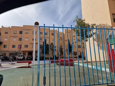 a fence in front of a large building at Appartement à louer Marrakech tous les services in Marrakech