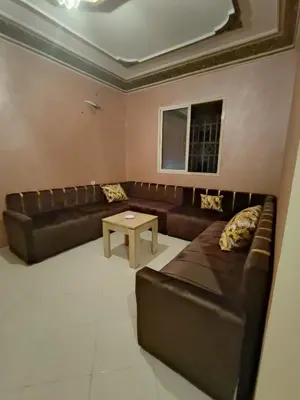a living room with a leather couch and a table at dyour marjan saada in Marrakech