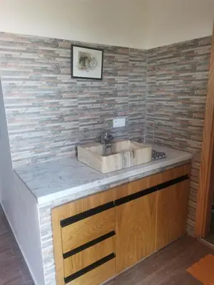 a bathroom with a sink and a brick wall at Villa Zaina in Marrakech