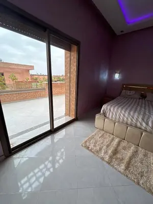 a bedroom with a bed and a large window at villa Marrakesh in Marrakech