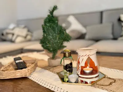 a coffee table with a candle and a remote control at Ruby in Marrakech