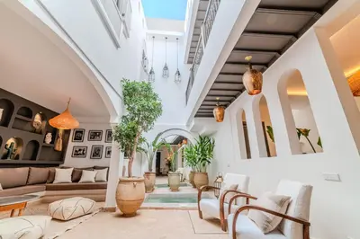 a living room with potted plants and ceilings at Riad Dar Jamila Breakfast 10mn to Jamaa Al Fna in Marrakech