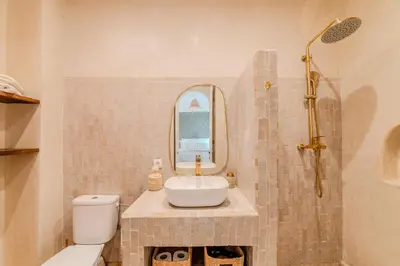 a bathroom with a sink and a toilet and a mirror at Riad Dar Jamila Breakfast 10mn to Jamaa Al Fna in Marrakech