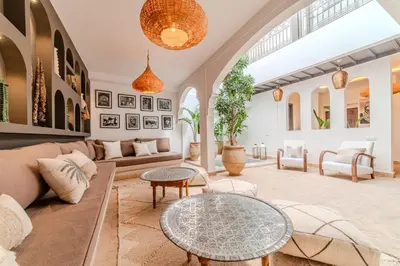 a living room with a couch and a table at Riad Dar Jamila Breakfast 10mn to Jamaa Al Fna in Marrakech
