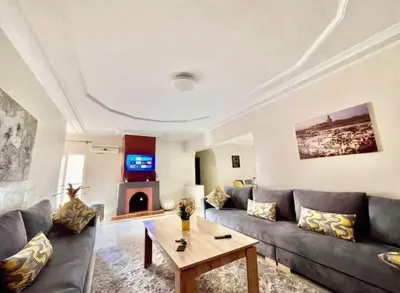 a living room with a couch and a table at Apparetement 2 chambres in Marrakech