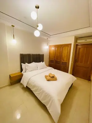 a bedroom with a bed with two towels on it at Gueliz center with pool and parking in Marrakech
