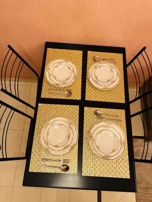three plates on display on a table with chairs at Gueliz center with pool and parking in Marrakech