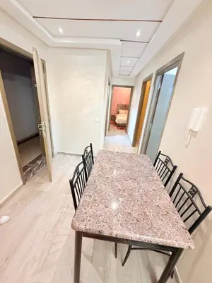 a dining room with a table and chairs at Appartement Calme Parfait & Centre-ville in Marrakech