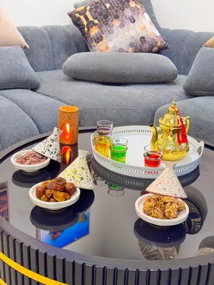 a coffee table with plates of food on it at Appartement luxe au cœur de Marrakech in Marrakech