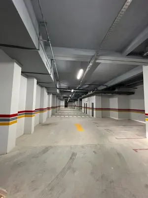 a large empty parking garage with white walls at Luxury Family Duplex in the Best Area of Marrakech with Pool and Garden in Marrakech
