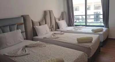 two beds in a room with a large window at Luxury Family Duplex in the Best Area of Marrakech with Pool and Garden in Marrakech