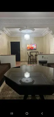 a living room with a couch and a table at Cozy appartment in Marrakech