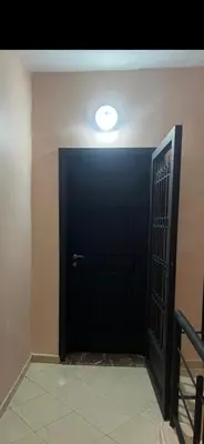 a black door with a light on top of it at Cozy appartment in Marrakech