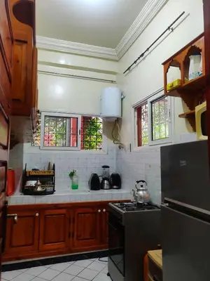 a kitchen with a stove and some windows at APPARTEMENT DAR MARRAKECh G27 N7 in Marrakech