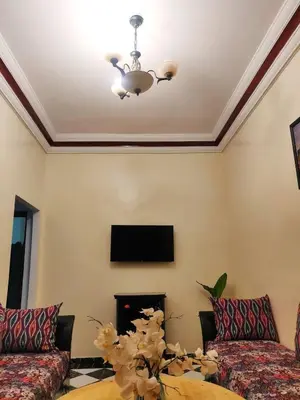 a living room with two couches and a tv at APPARTEMENT DAR MARRAKECh G27 N7 in Marrakech