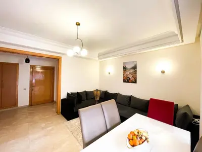 a living room with a couch and a table at appartement luxueuse in Marrakech