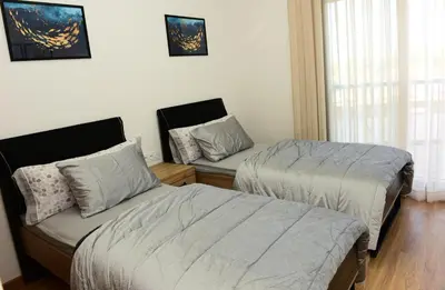 a bedroom with two beds and a window at Welcome Home! in Marrakech
