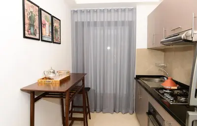 a small kitchen with a table and a counter top at Welcome Home! in Marrakech