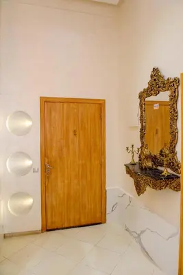a room with a wooden door and a mirror at Marrakech in Marrakech