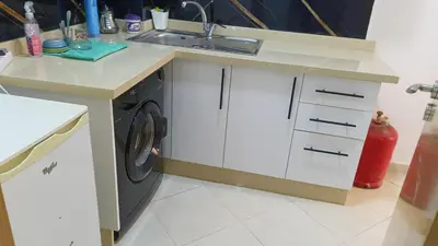 a kitchen with a sink and a washing machine at marrakech mountazah al jadid in Marrakech