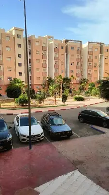 three cars parked in a parking lot in front of a building at marrakech mountazah al jadid in Marrakech
