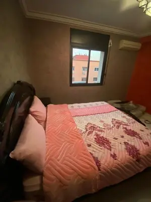 a bed in a room with a window at Marrakech gliz in Marrakech